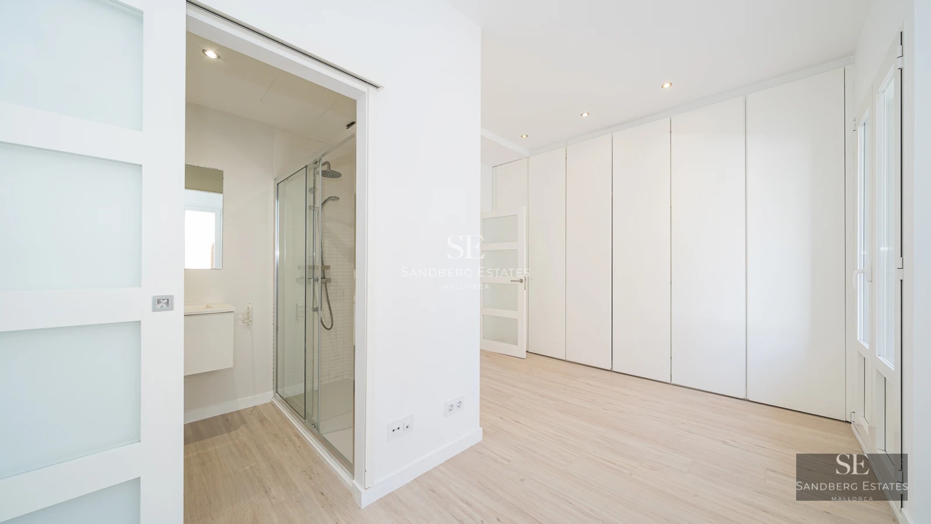 Panoramic view of a modern villa with infinity pool and spacious terraces. Minimalist design and abundant natural light.