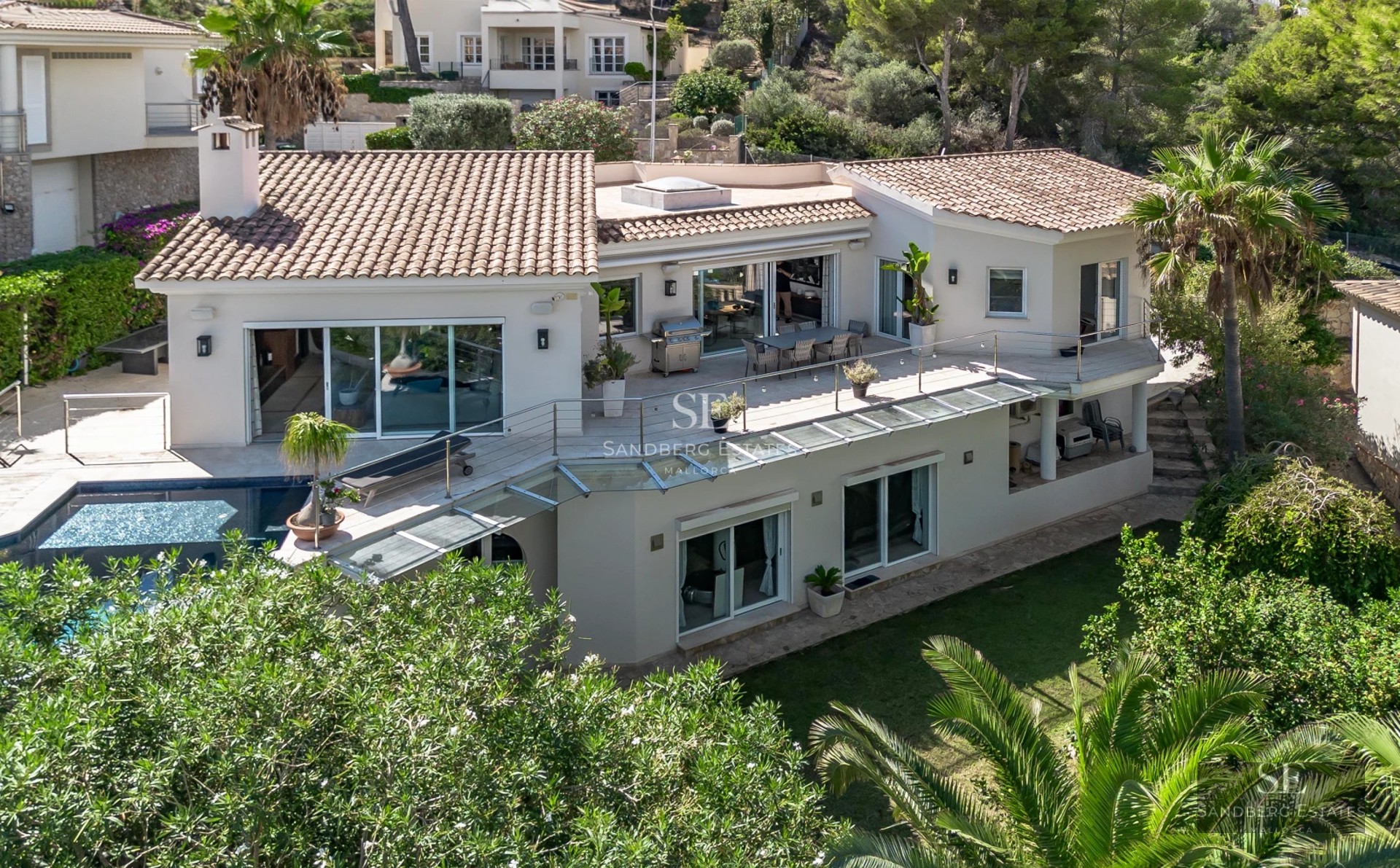 Spacious living room with picture windows, modern fireplace, designer furniture, and spectacular sea views. Natural light and high-quality finishes.