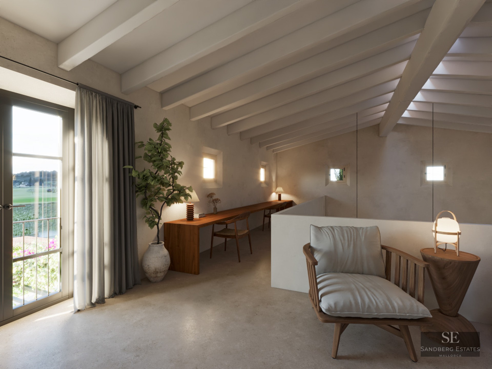 A mezzanine workspace featuring a long wooden desk, exposed white ceiling beams, and a stylish lounge chair by a balcony.