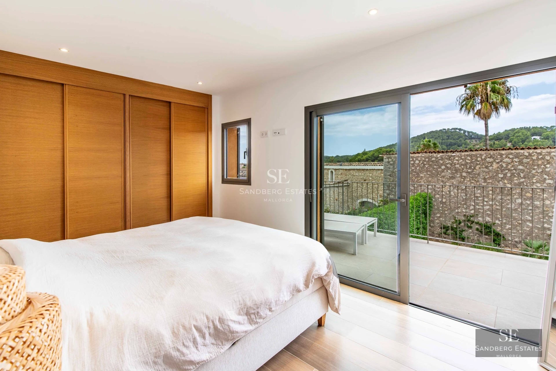 Expansive terrace with swimming pool, sun loungers, and panoramic views. Modern architecture with large windows and lush landscaping.