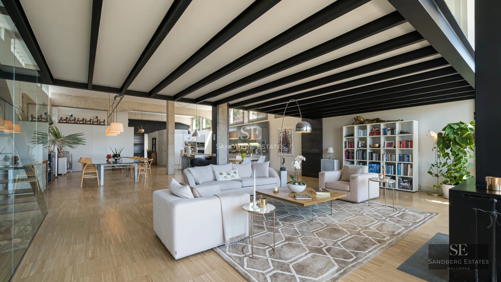 Exterior view of a modern villa with infinity pool, lush vegetation, and minimalist architectural design.