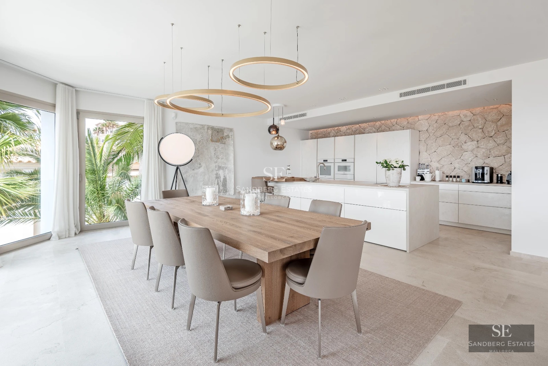 Spacious living room with floor-to-ceiling windows, modern fireplace and designer furniture. Spectacular city views.