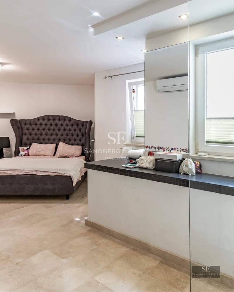 View of reflecting pool, modern facade, lush vegetation. Minimalist design with ambient lighting.