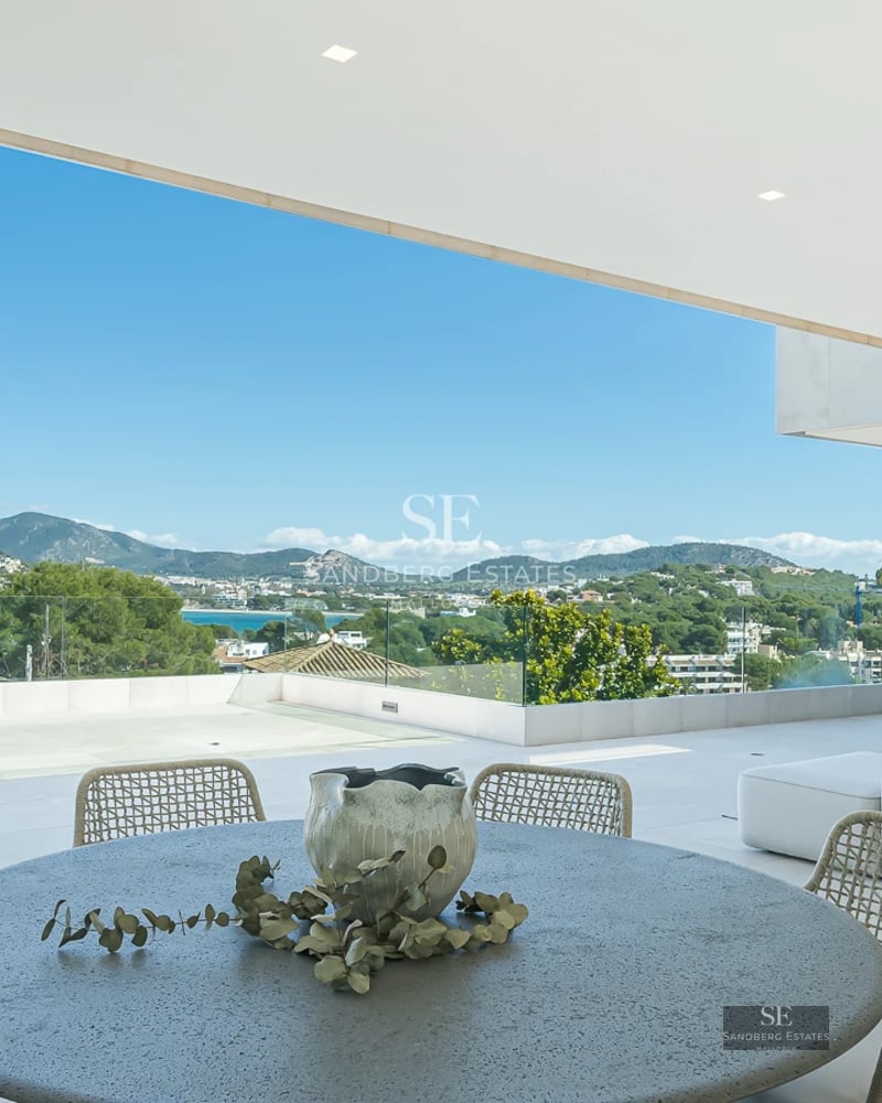Exterior view of a modern house with a pool, large garden, terraces, and panoramic windows. Minimalist architectural design.