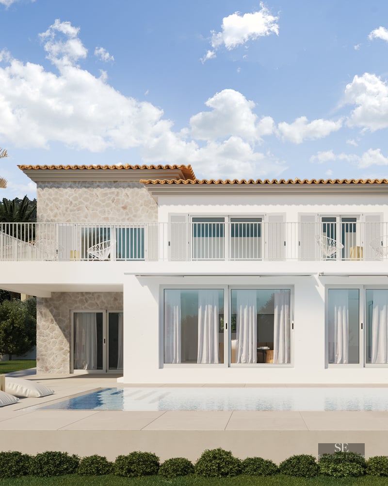 Modern white villa with a pool, stone wall accents, and scenic mountains under a blue sky.