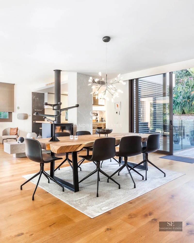 Modern exterior with reflecting pool, lush gardens, and large windows. Minimalist architecture and elegant landscaping.