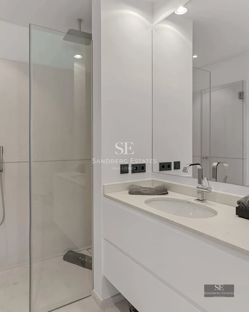 View of a lush garden with impeccable lawn, manicured shrubs and leafy trees, creating a serene and private atmosphere.