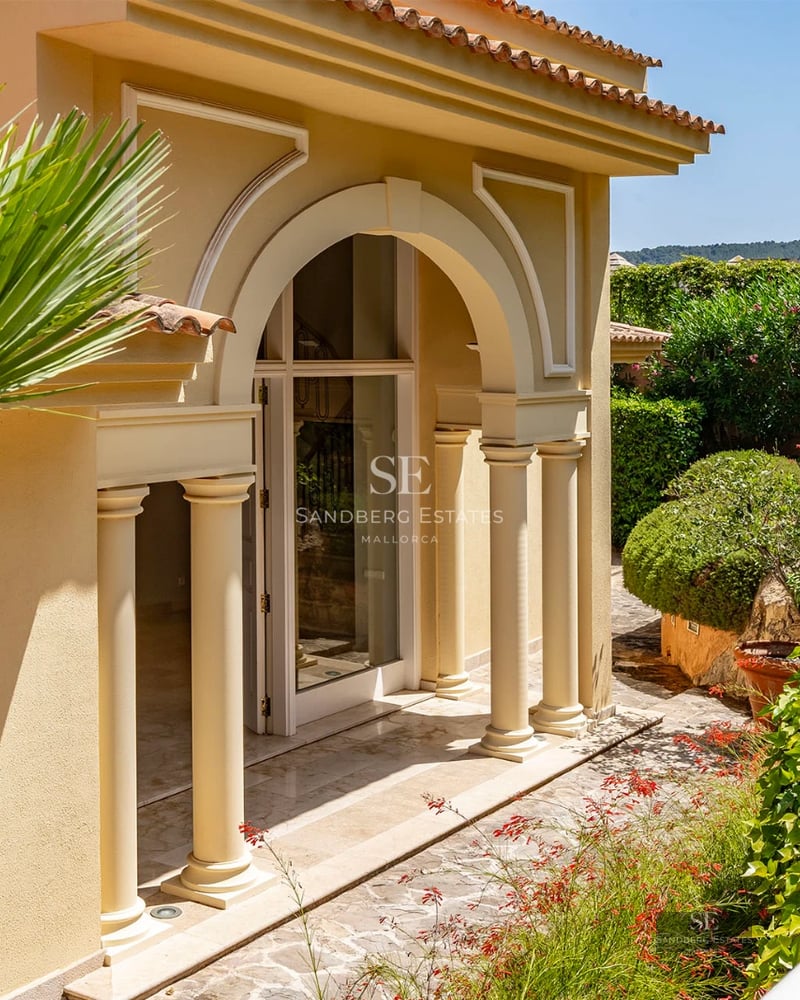 Spacious living room featuring a fireplace, large windows, and panoramic views. Leather sofa, designer rug, and modern decor.