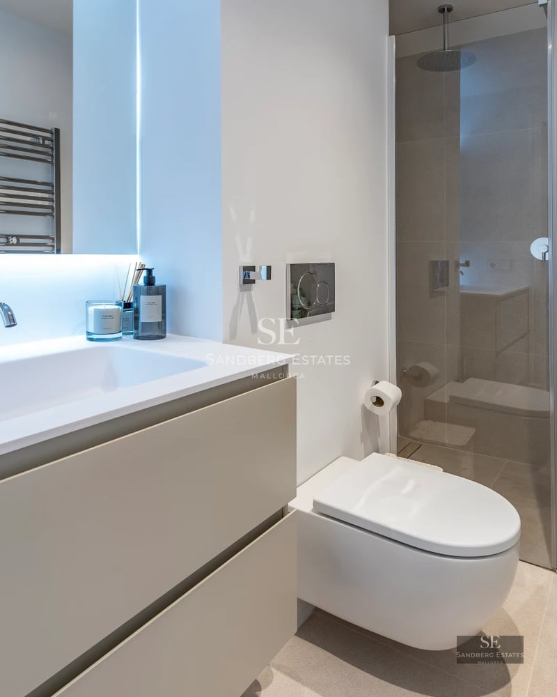 Exterior view of a modern villa with a pool, gardens, and large windows reflecting minimalist architectural design.