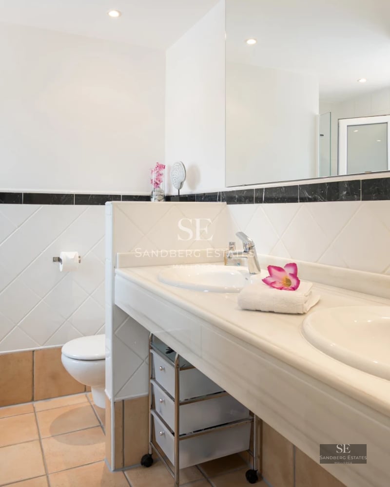 Exterior view of a luxurious villa with a pool, lush garden and modern architecture. Warm ambient lighting.