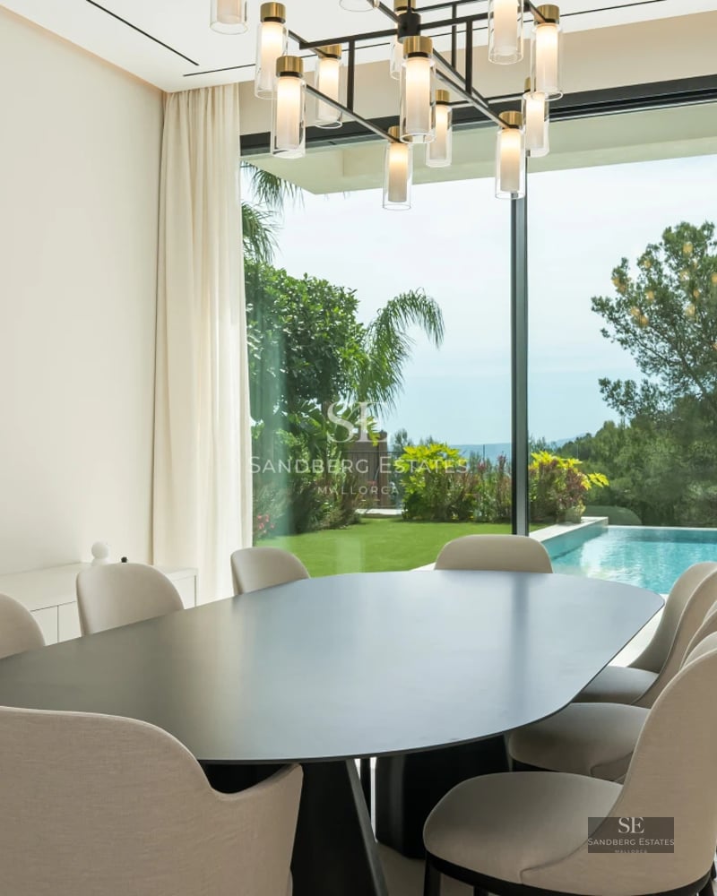 Spacious terrace with infinity pool, sun loungers, and stunning views. Modern design with glass railing.