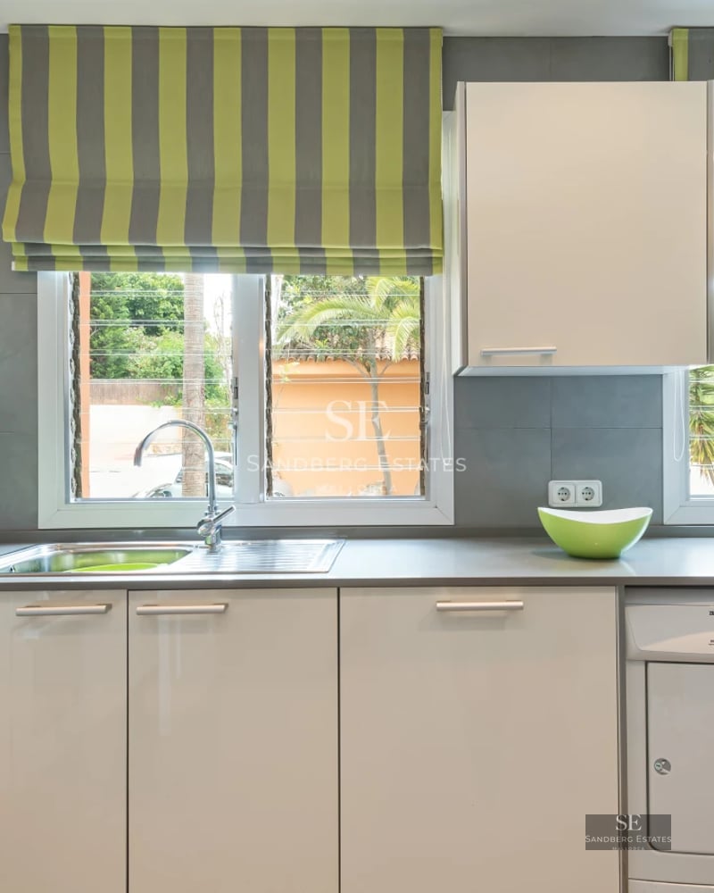 Spacious balcony with panoramic sea views. Modern design featuring glass railings and stylish furniture. Bright and airy.