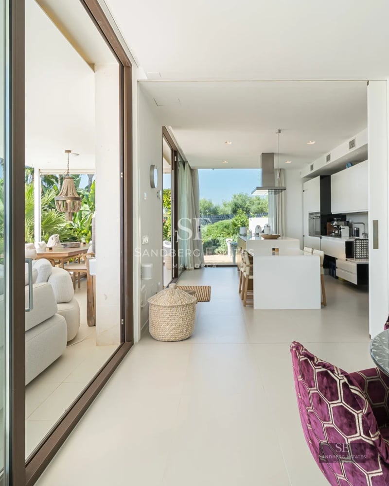 Expansive terrace featuring an infinity pool with ocean views. Modern design, elegant furnishings, and lush greenery.