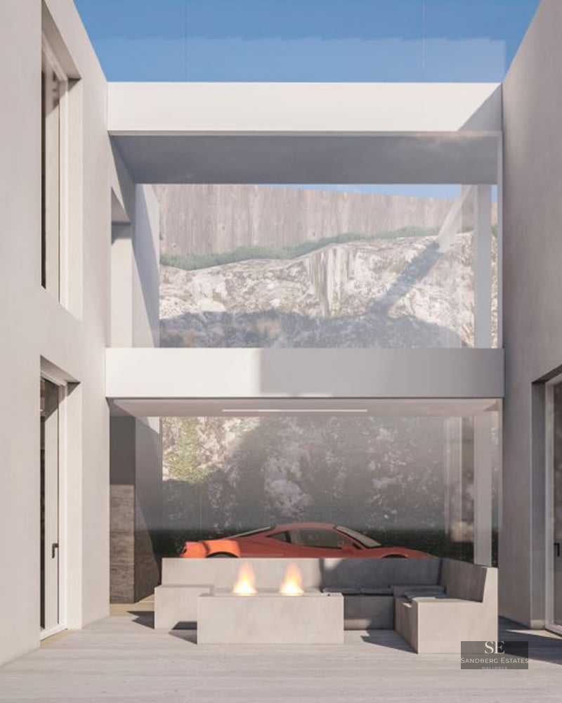 Minimalist white terrace featuring a modern fire pit, concrete seating, and a red sports car visible in the background.