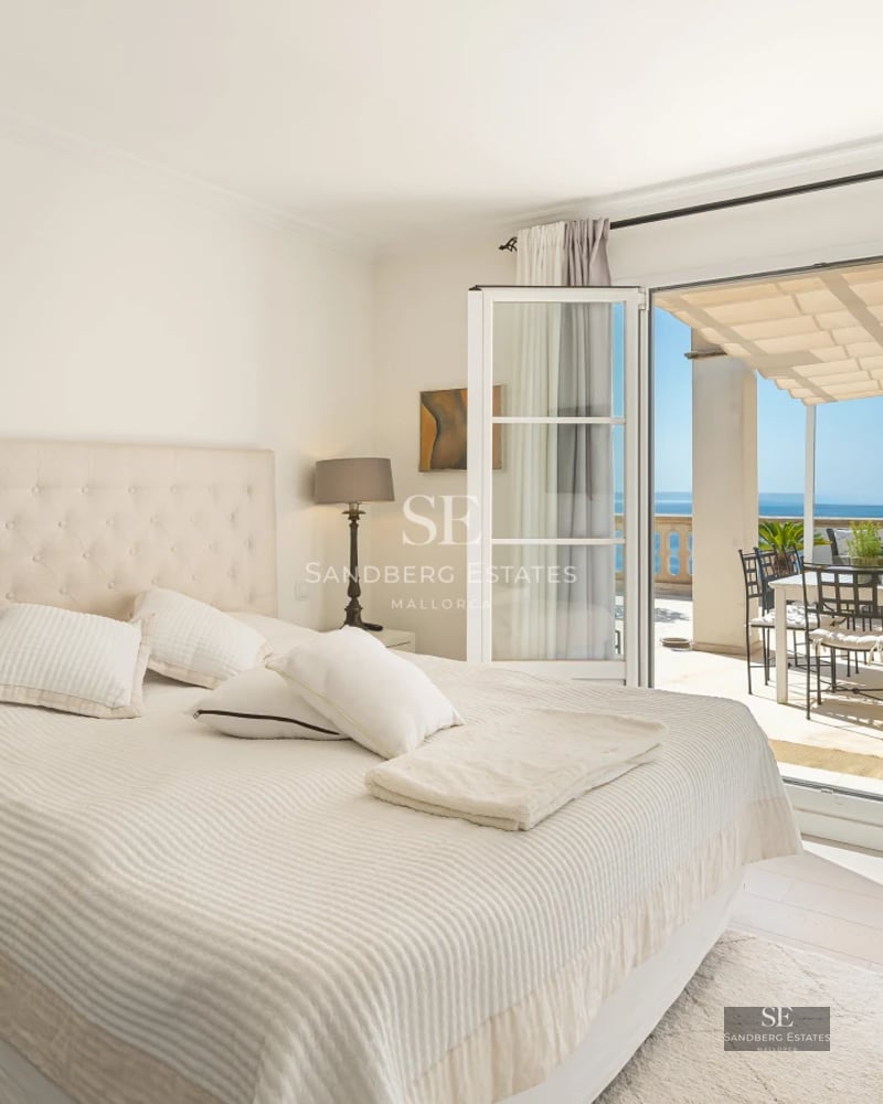 Modern living room with large windows, abundant natural light, and stunning views. Designer furniture and high-quality finishes.