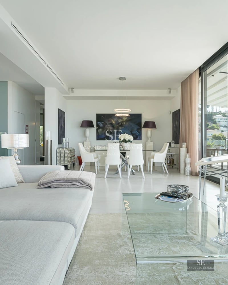 Exterior of modern villa with infinity pool, sun loungers, and unobstructed views. Minimalist design and high-end finishes.