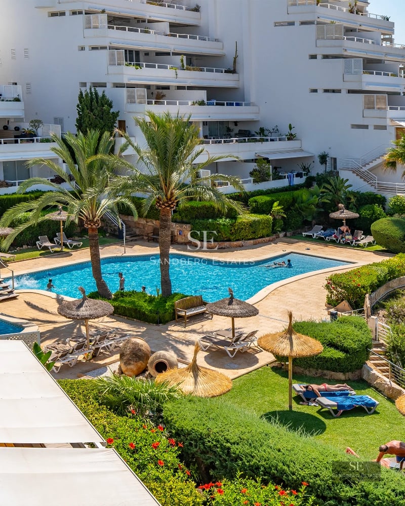 Exterior view of a modern villa featuring an infinity pool, terrace, and large windows offering panoramic sea views.