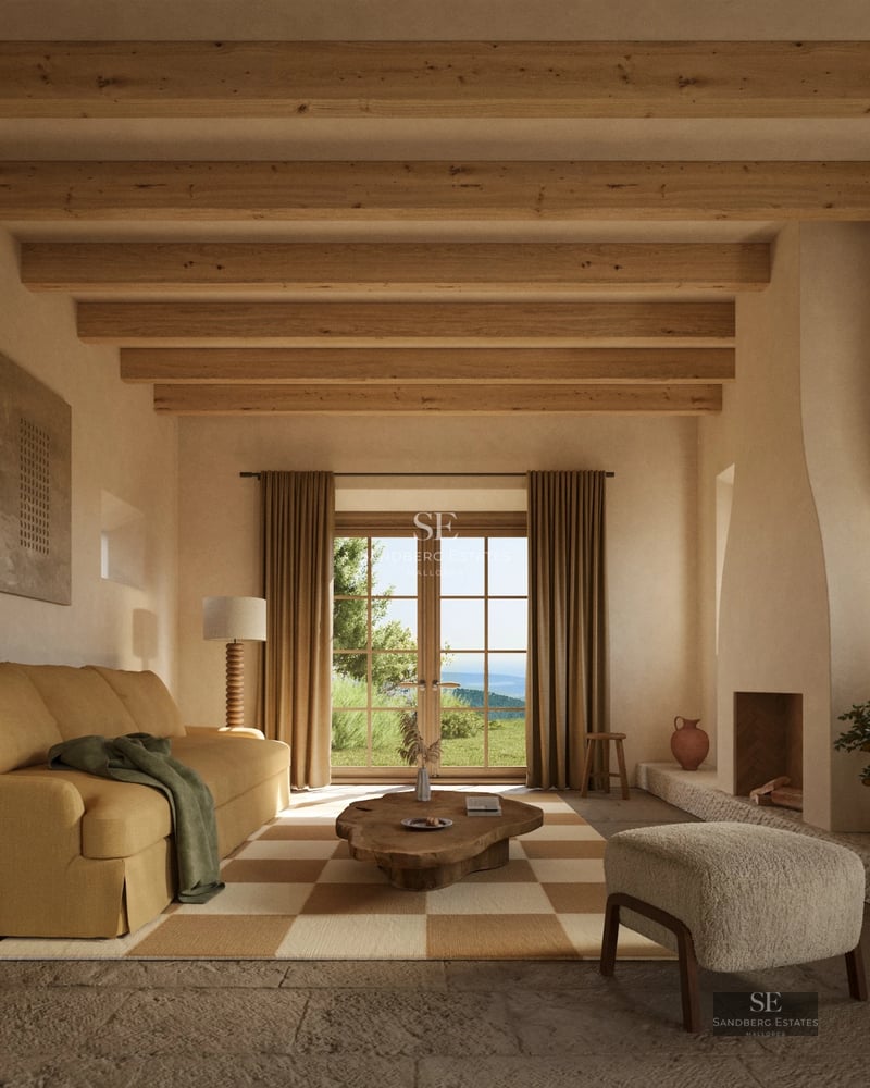 Spacious living room with fireplace, large windows, and sea view. Modern and elegant furniture. Light wood flooring.