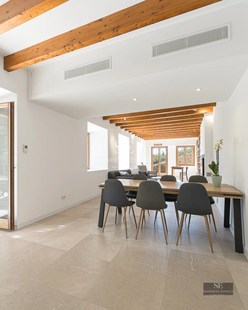 Exterior view of a modern villa with pool, expansive terraces, minimalist design, and lush greenery. White facade and large windows.