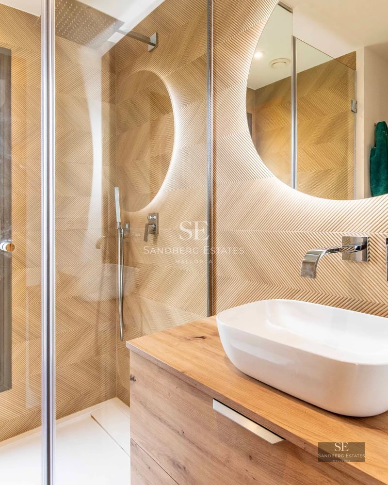 Spacious balcony with private pool and panoramic sea views. Modern design with glass railing and sun loungers.