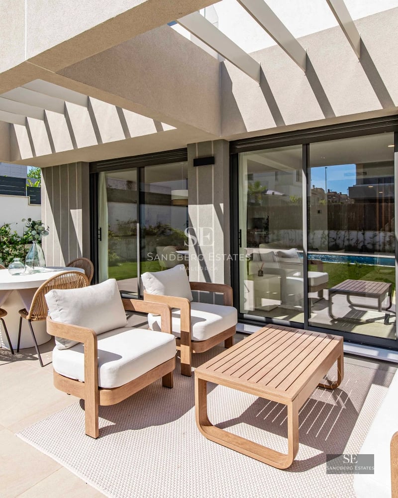 Modern exterior view with reflecting pool, large windows, glass balconies, and minimalist design. Soft ambient lighting.