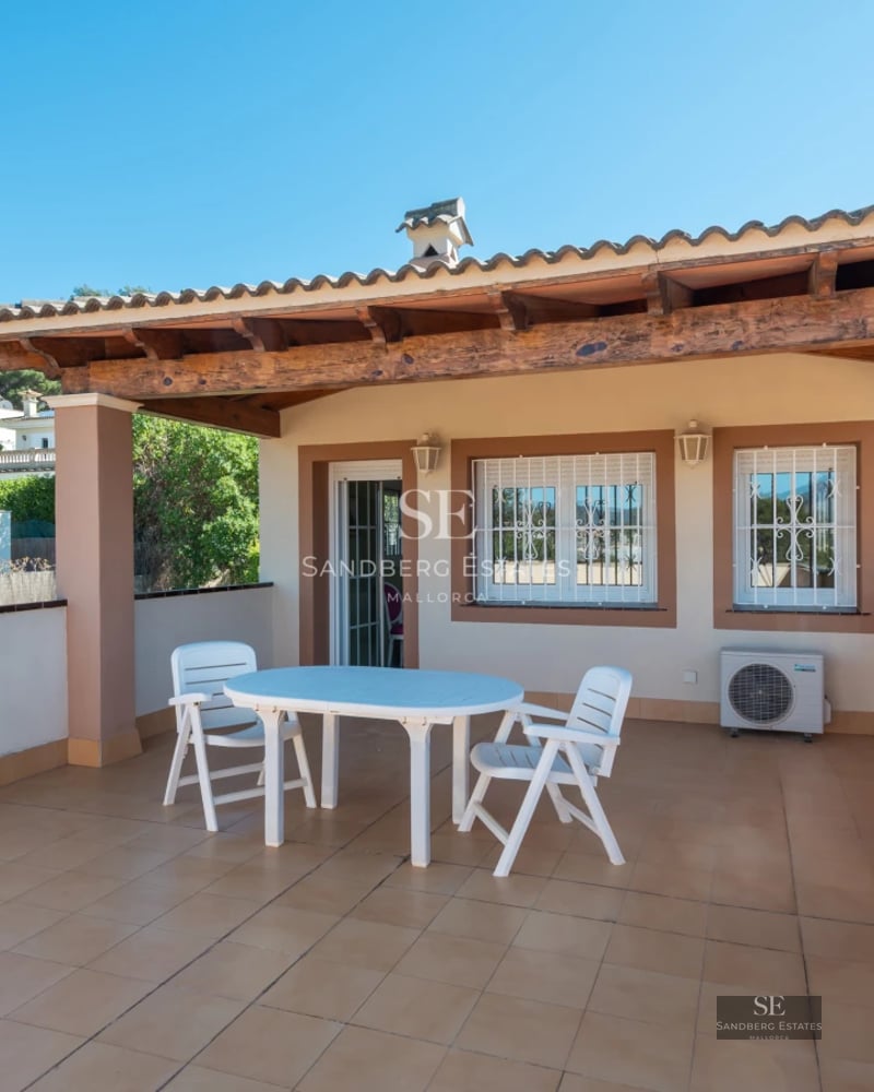 Spacious balcony with ocean views, modern outdoor furniture, and tiled flooring. Sleek and bright design.