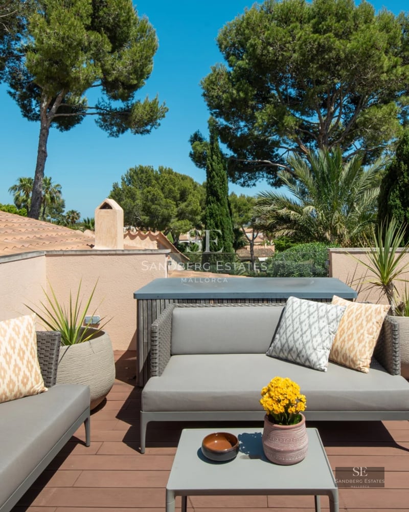 Exterior view of modern villa with pool, large garden, expansive windows, and minimalist architecture. Well-maintained landscaping.