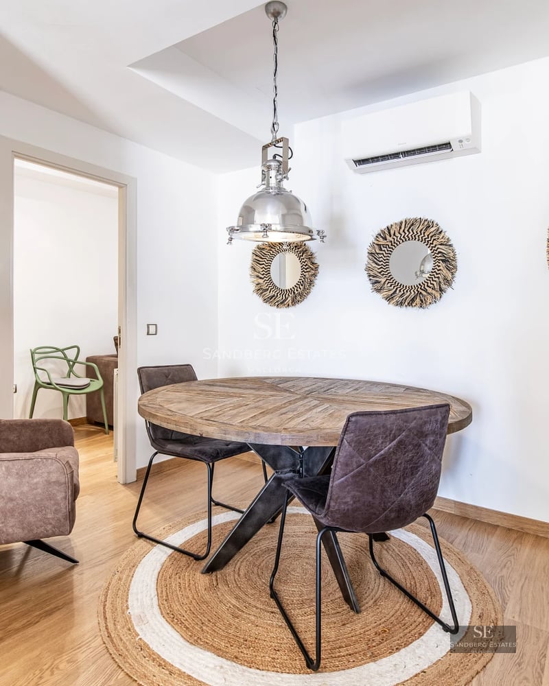 Wide view of a luxurious terrace with pool, sun loungers, and lush vegetation. Modern and elegant design with high-quality finishes.