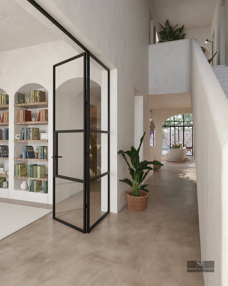 Bright hallway featuring arched built-in bookshelves, black-framed glass doors, and a minimalist white staircase.