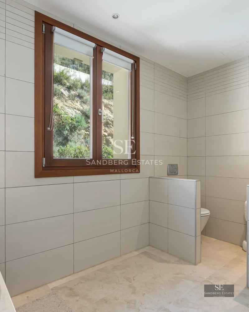 Exterior view of a luxurious house featuring a pool, manicured garden, and modern architecture with large windows.