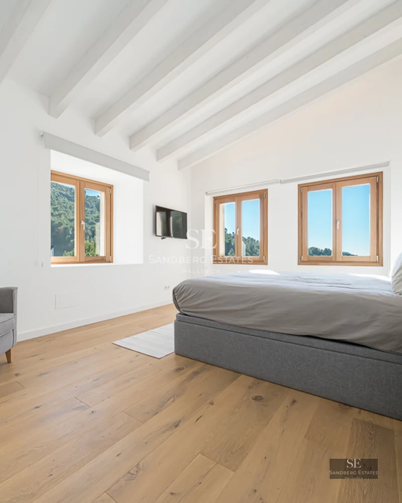 Expansive terrace with pool, sun loungers, landscaped garden, and view. Modern architecture with large windows.