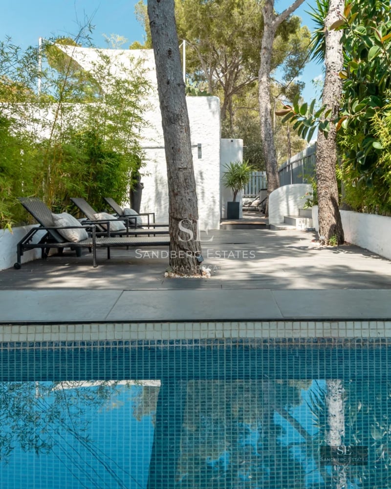Infinity pool view with manicured lawn and modern architecture. Ideal for relaxation and outdoor entertainment.
