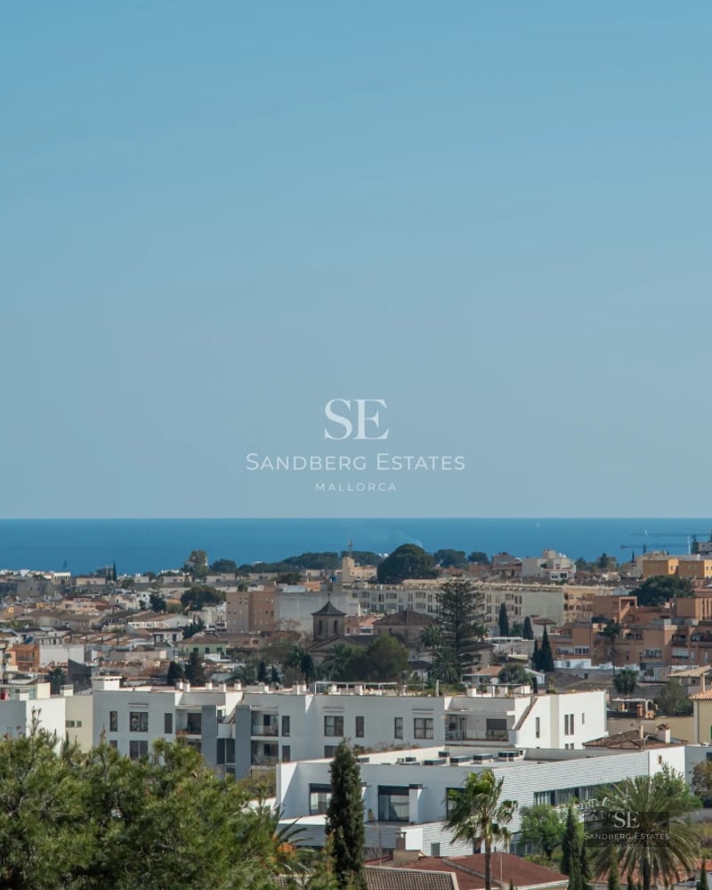 View of a modern villa featuring a pool, large windows, a sunny terrace, and lush greenery. Contemporary design and high-end finishes.