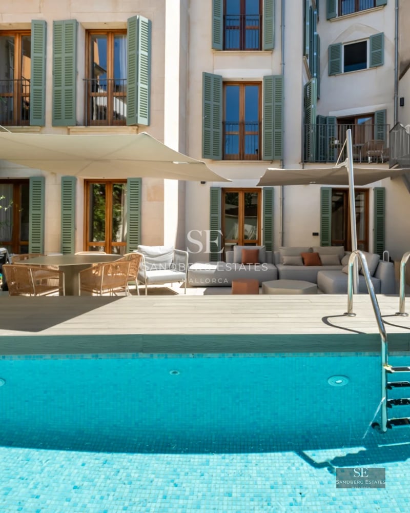 Exterior view of a modern villa with an infinity pool, manicured lawn, and large windows. Minimalist and elegant design.