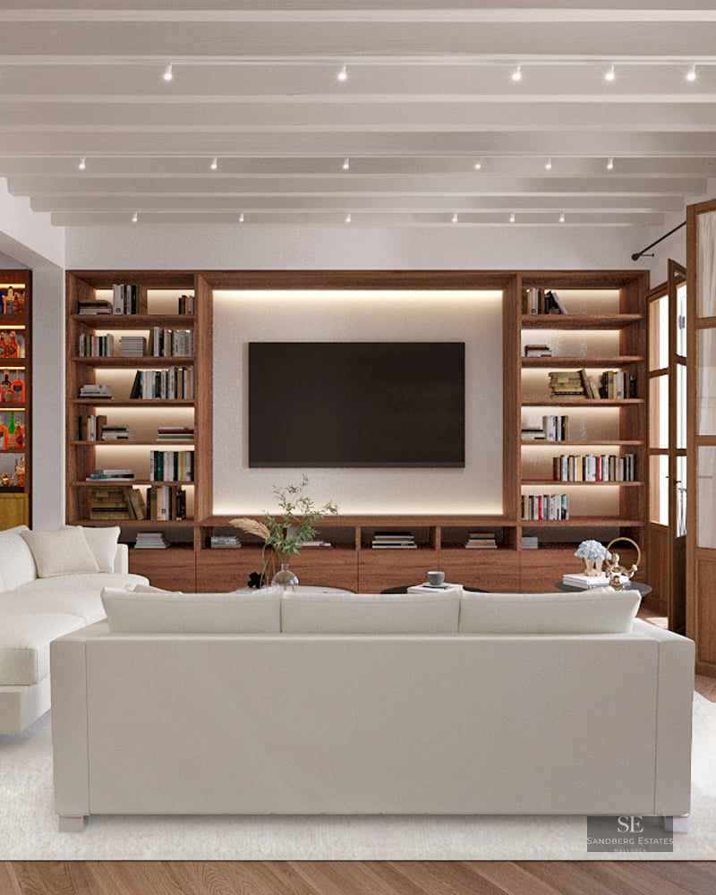 Modern living room featuring white sofas, a large wooden built-in library with TV, a home bar, and white beamed ceilings.