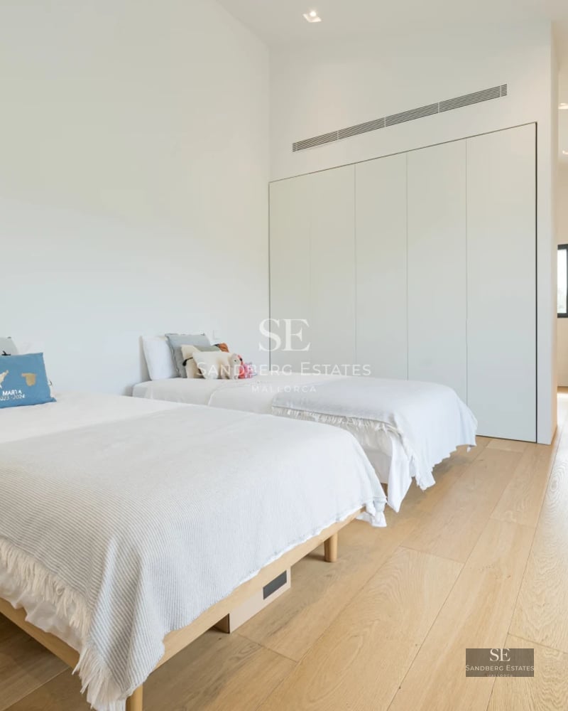 Bright interior featuring expansive windows, sea views, hardwood floors, and modern décor. Open and inviting space.