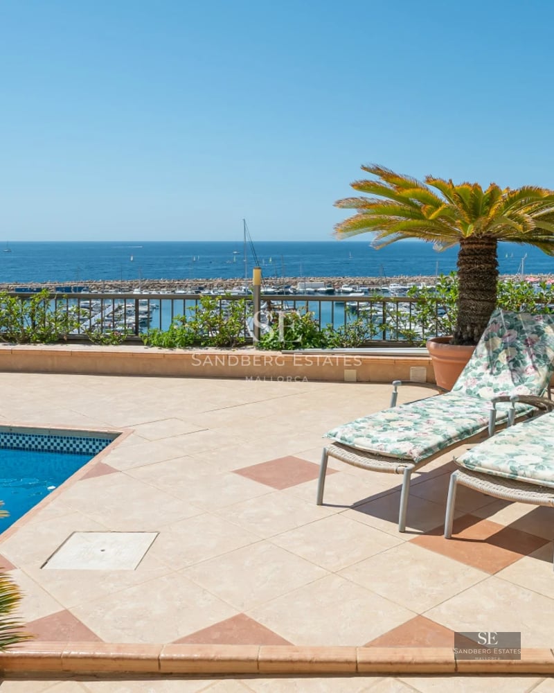 Modern exterior featuring a shimmering pool and contemporary architecture. Large windows and sleek design.