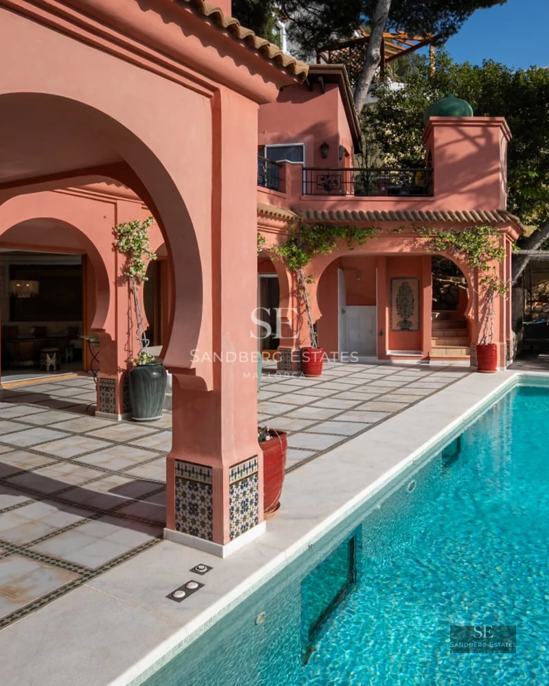 Expansive pool with sundeck, lounge chairs, and panoramic views. Modern, sleek design with lush greenery.