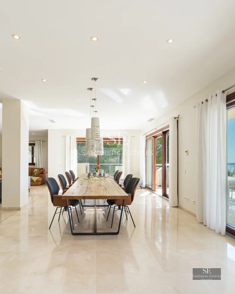 Expansive terrace featuring an infinity pool and ocean views. Modern architecture, stylish outdoor furniture, and lush greenery.