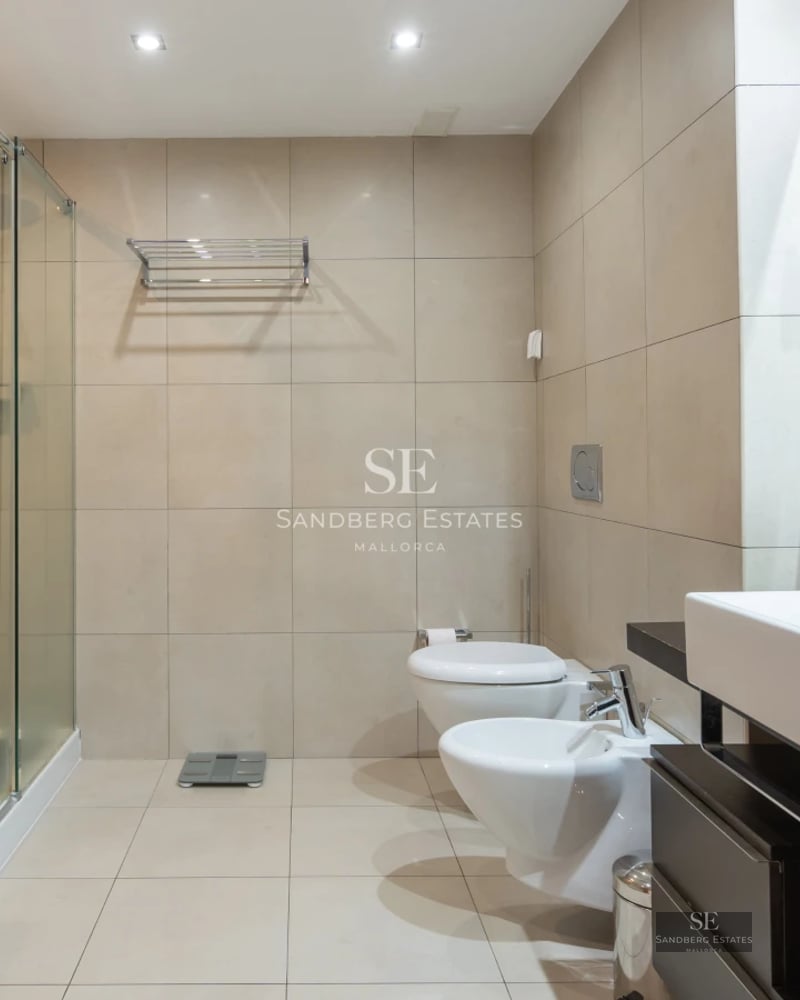 Exterior view of a luxury villa with infinity pool, surrounded by greenery. Modern architecture and spacious terraces.