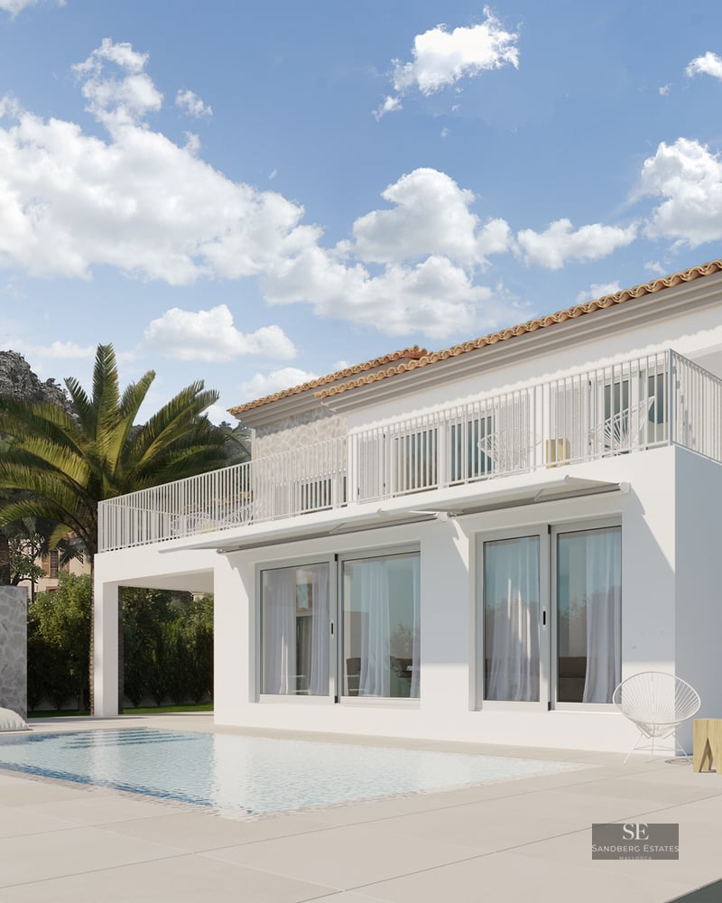 Modern white and stone villa with a swimming pool, palm trees, and mountain backdrop under a blue sky.