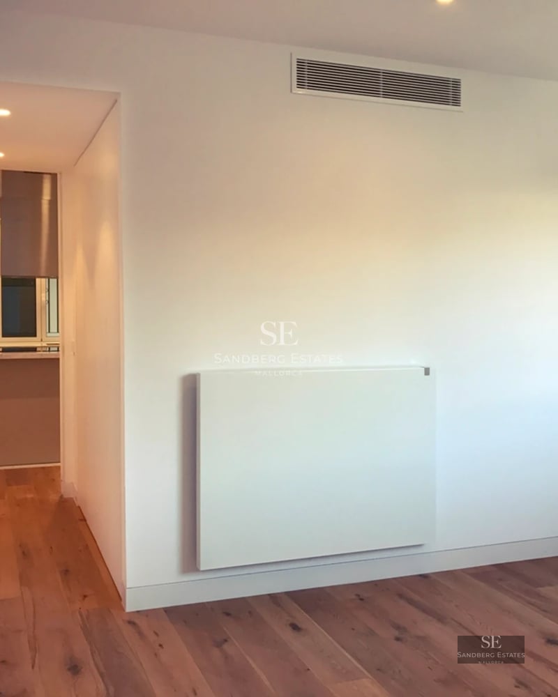 Spacious terrace with pool, sun loungers and sea view. Modern design with glass railing and light tile flooring.