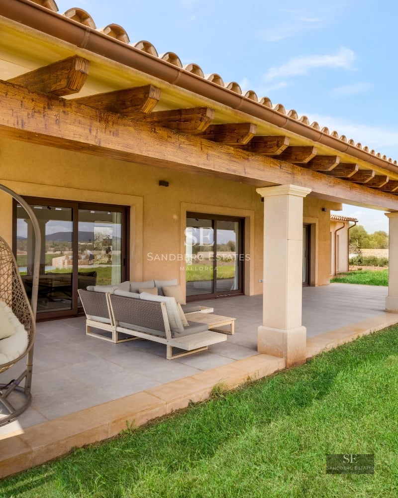Exterior view of a modern house with a pool, manicured garden, and large windows. Contemporary architecture and landscape design.