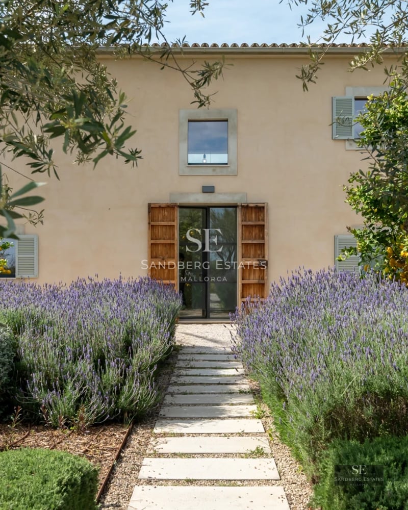 Exterior view of a modern villa with an infinity pool, surrounded by lush gardens and spacious terraces. Minimalist architectural design.