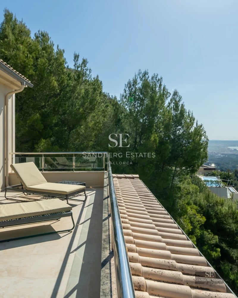 Spacious living room with panoramic windows, light wood floors, modern fireplace, and designer furniture. Sea view and balcony.