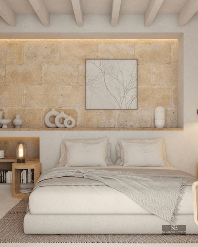 Minimalist bedroom featuring a textured stone accent wall, wooden ceiling beams, and warm ambient lighting.