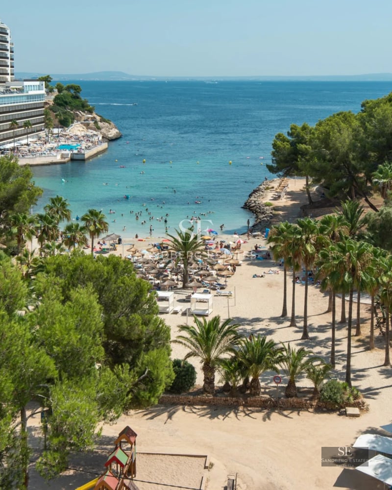 Spacious balcony with sea view, designer furniture, glass railing. Elegant outdoor space with natural light.