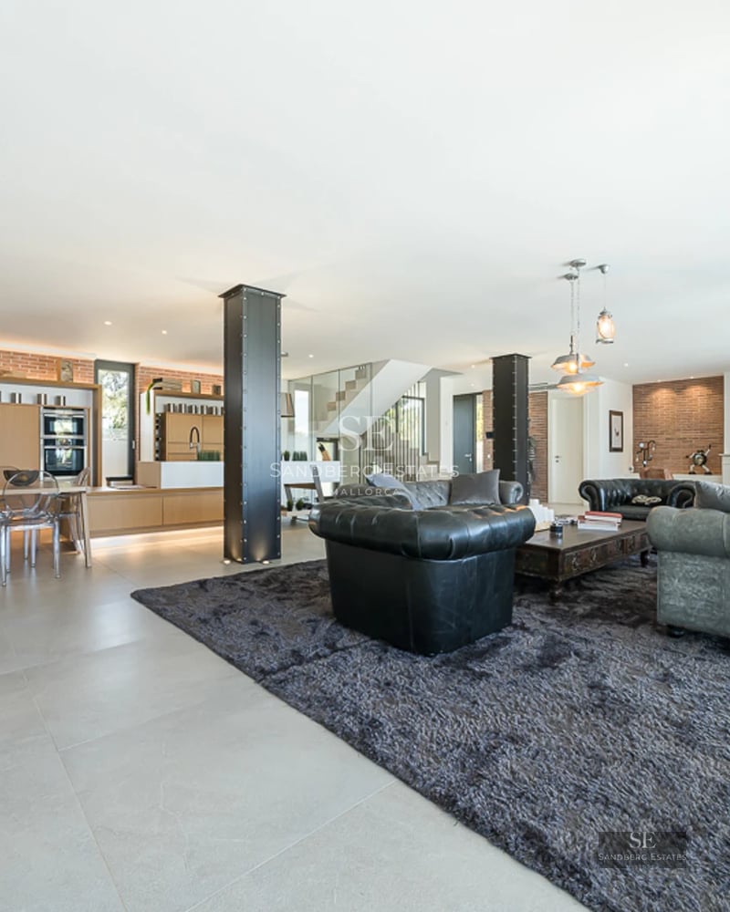 Spacious living room with floor-to-ceiling windows, pool reflecting light, modern design, leather sofas, and elegant coffee table. Natural lighting.