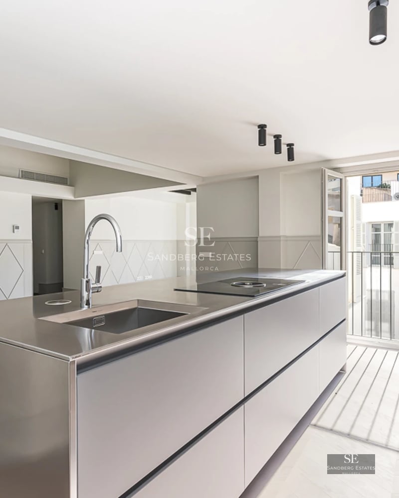 Spacious living room with picture windows, sea views and modern furniture. Light wood floors and neutral color palette.