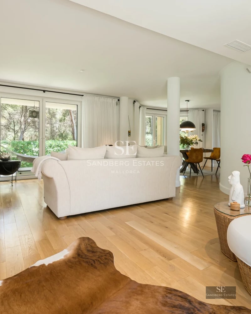 Aerial view of a modern infinity pool, surrounded by greenery and a minimalist terrace. Sleek architectural design.